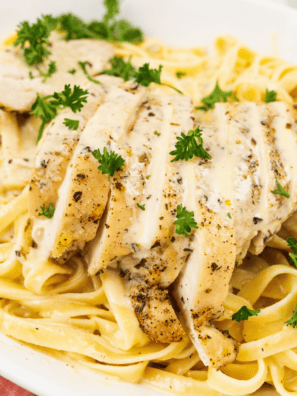 Delicious and creamy Copycat Carrabba’s Alfredo sauce served with pasta"