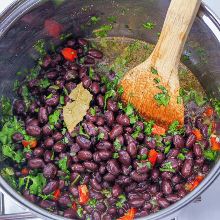 Heat oil in a saucepan, then add black beans, sugar, chili powder, and garlic powder. Stir and simmer for 10-15 minutes to blend flavors.