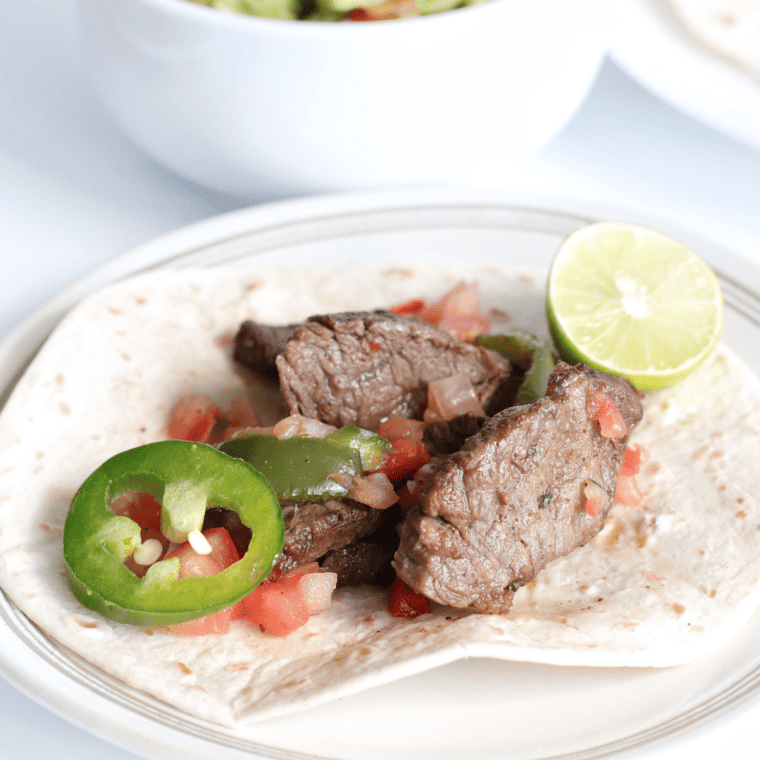 Copycat Chili’s Steak Fajitas served with marinated flank steak, bell peppers, onions, and tasty toppings.