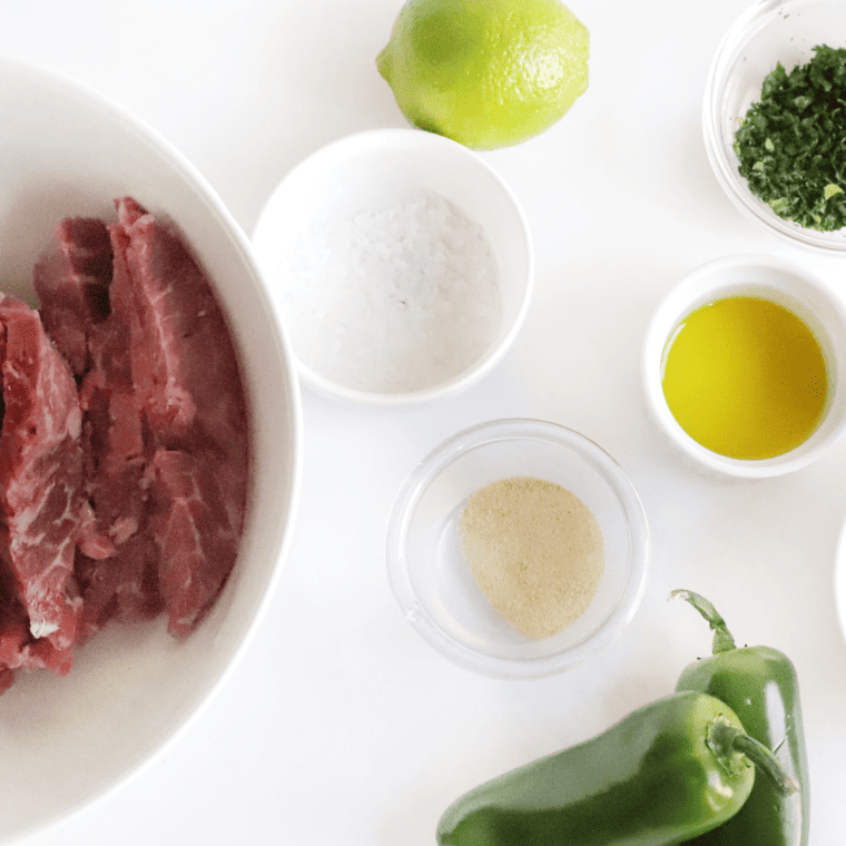 Ingredients needed for Copycat Chili’s Steak Fajitas Recipe on kitchen table.