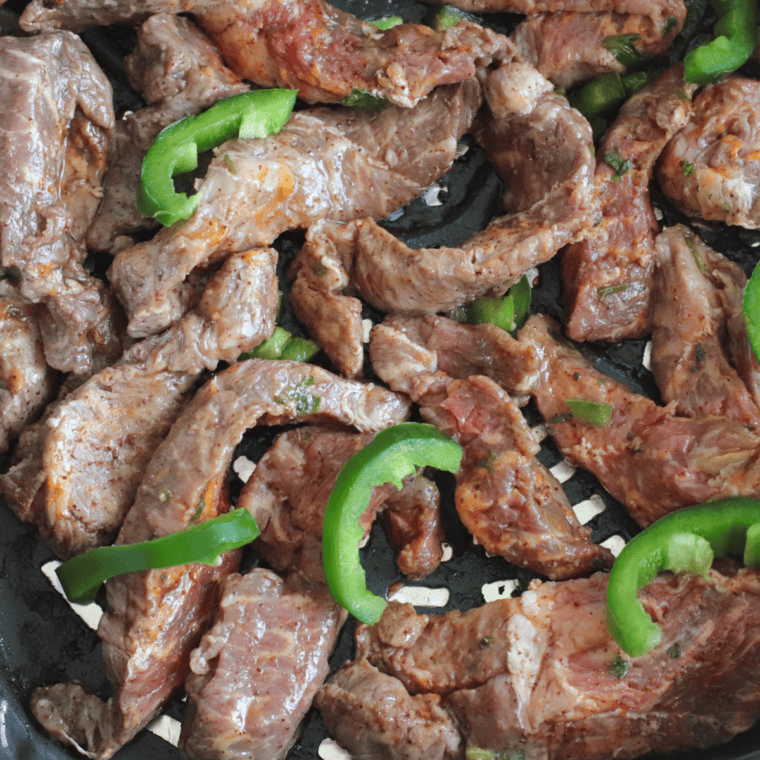 Placing marinated flank steak in the air fryer basket and cooking at 400°F, flipping halfway, until desired doneness is reached.