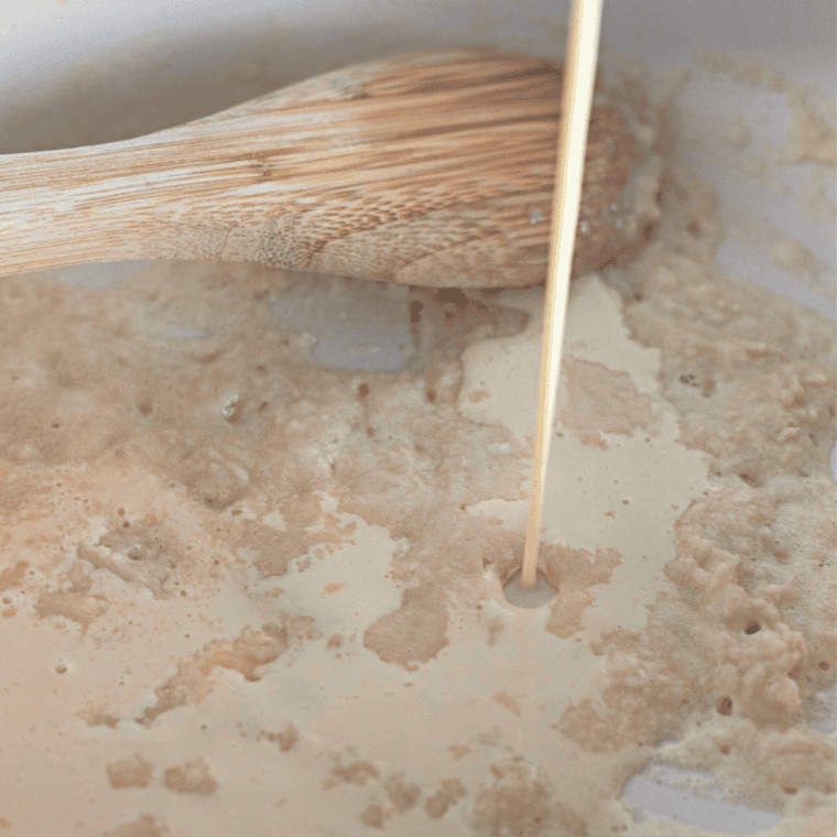 Stirring milk, powdered milk, and cornstarch in a saucepan over medium heat to thicken.