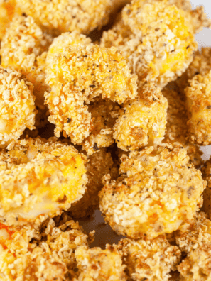 Homemade copycat Popeyes popcorn shrimp—crispy, golden, and perfectly seasoned bite-sized shrimp on a plate with dipping sauce.