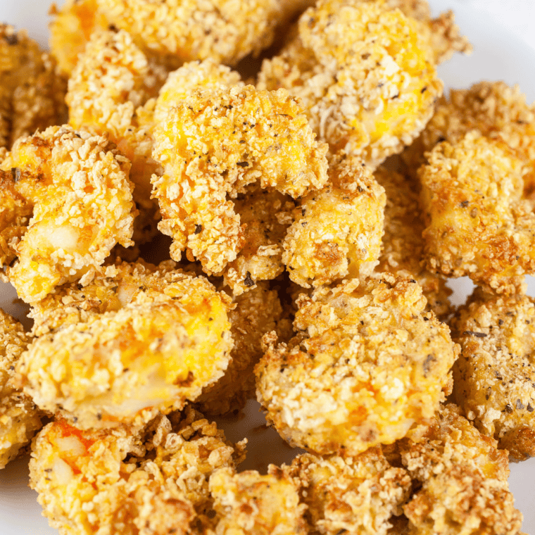 Homemade copycat Popeyes popcorn shrimp—crispy, golden, and perfectly seasoned bite-sized shrimp on a plate with dipping sauce.