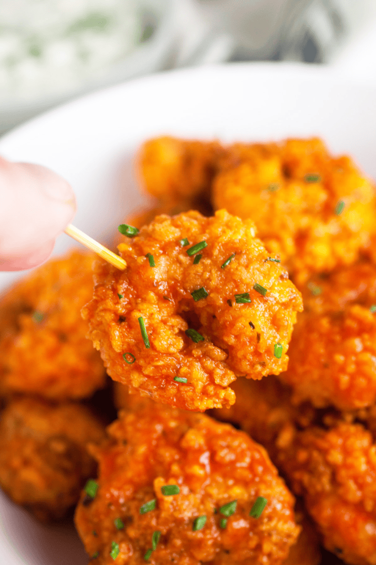 Golden, crispy homemade Popeyes-style popcorn shrimp with dipping sauce.