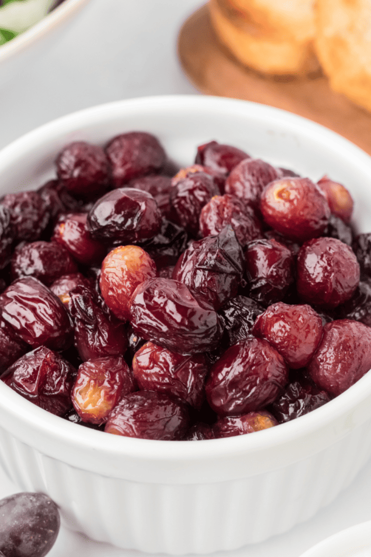 Fresh grapes dehydrating in an air fryer basket to make homemade raisins.