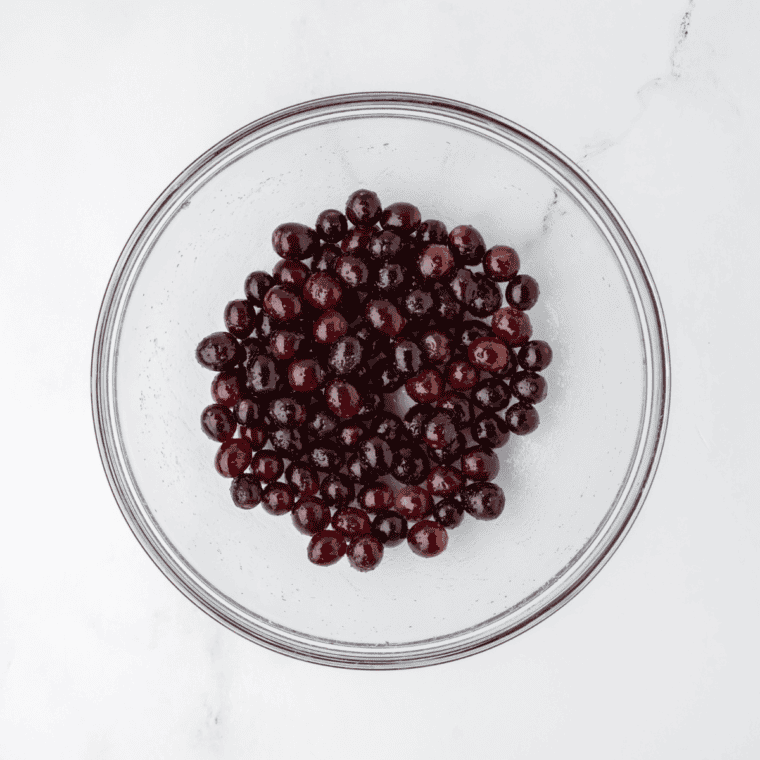 Fresh grapes being washed and dried with paper towel, stems removed.