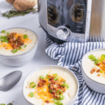 Instant Pot Panera Baked Potato Soup topped with crispy bacon, shredded cheese, and green onions.