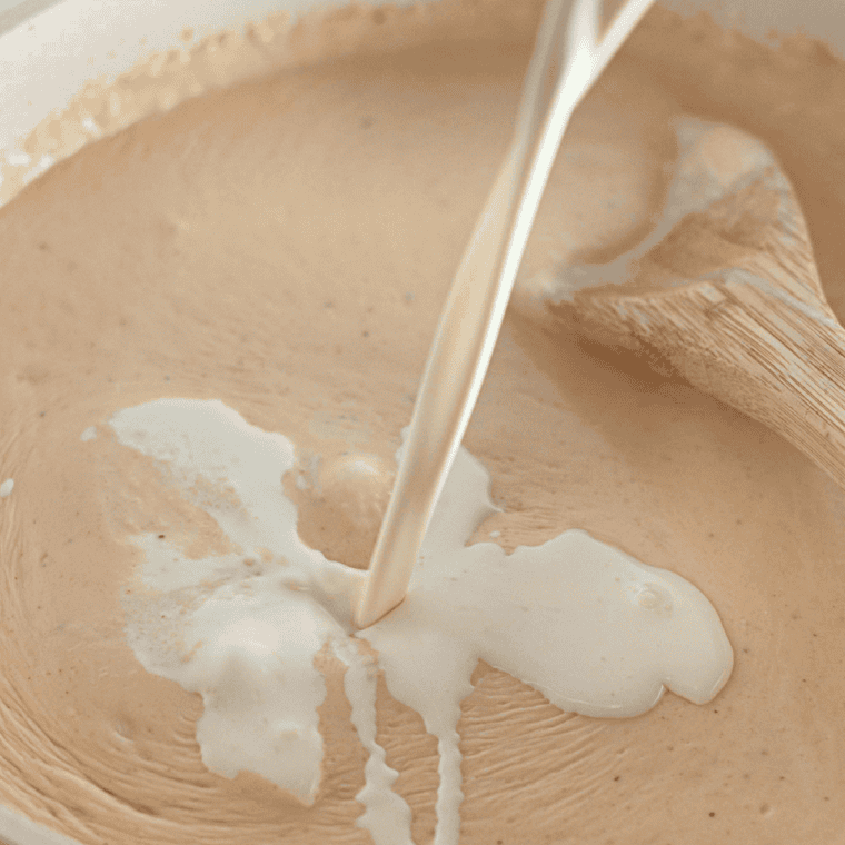 Melt butter and create a roux with flour, milk, and heavy cream.