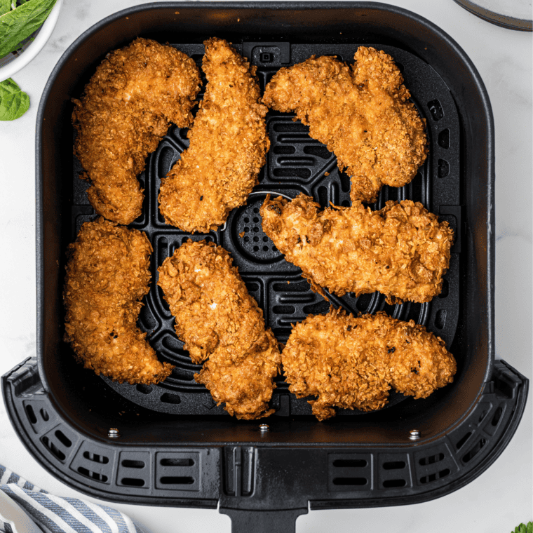 Cooked Chicken in KFC Crispy Strips Recipe air fryer basket.