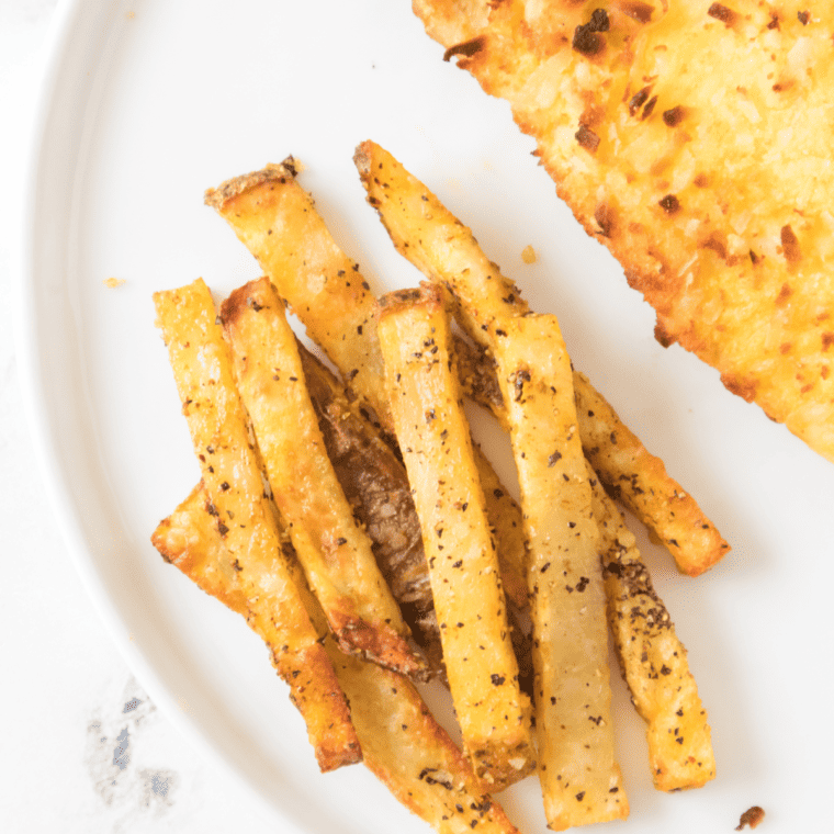 Golden, crispy homemade LongHorn Steakhouse-style fries served with a dipping sauce, perfect for any meal.