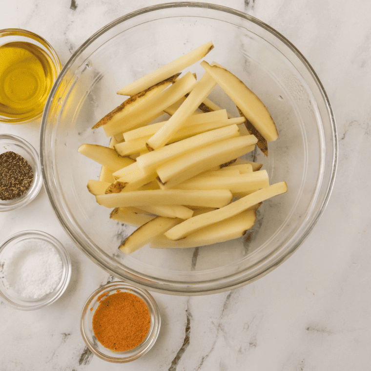 Ingredients needed for Longhorn Steakhouse Fries Recipe on kitchen table.