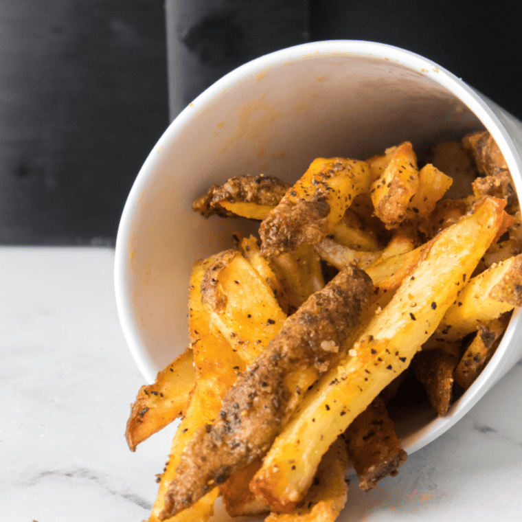 Crispy, golden homemade LongHorn Steakhouse-style fries served with a dipping sauce, ready to enjoy.