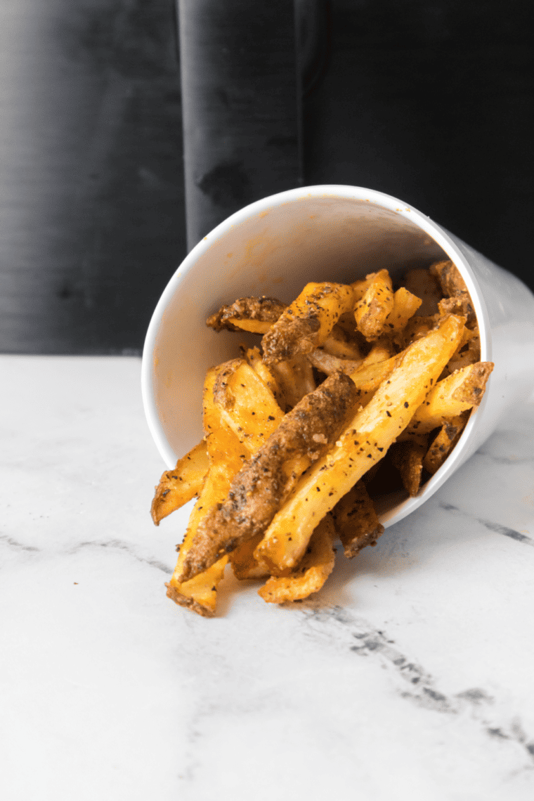 Golden, crispy homemade LongHorn Steakhouse-style fries served with a dipping sauce, ready to enjoy.