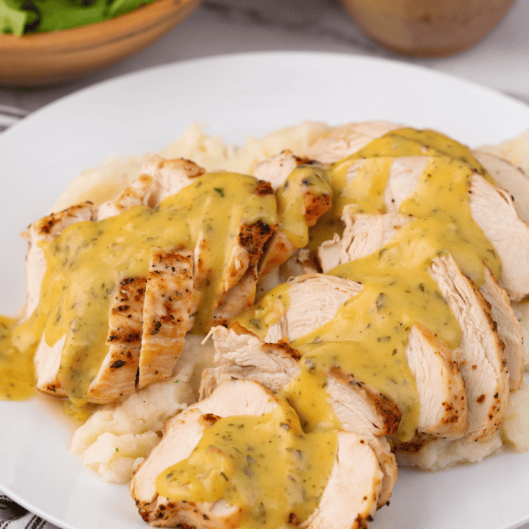 Homemade LongHorn Steakhouse honey mustard in a bowl with a spoon, perfect for dipping and drizzling.