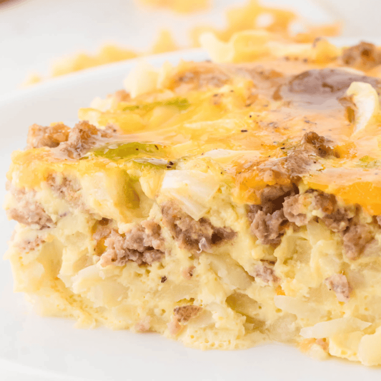 A hearty breakfast casserole made in the Ninja Foodi Possible Cooker Pro, featuring eggs, sausage, cheese, and potatoes, served in a baking dish.