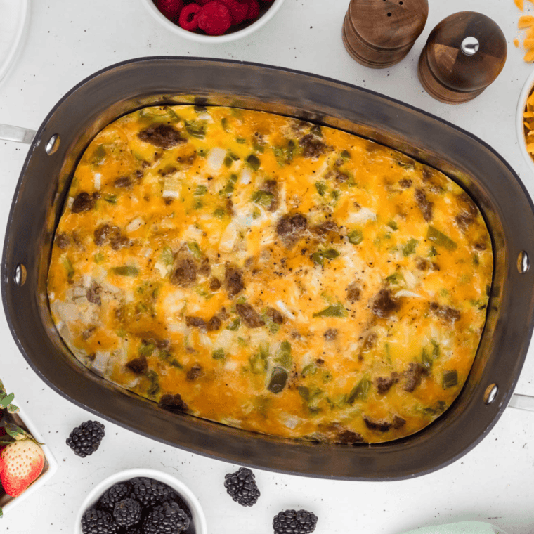 A hearty breakfast casserole made in the Ninja Foodi Possible Cooker Pro, featuring eggs, sausage, cheese, and potatoes, served in a baking dish.