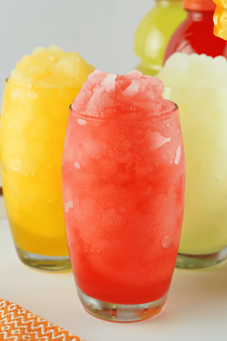  A refreshing glass of Red Robin Freckled Lemonade, made with fresh strawberries and lemonade, garnished with a lemon slice.