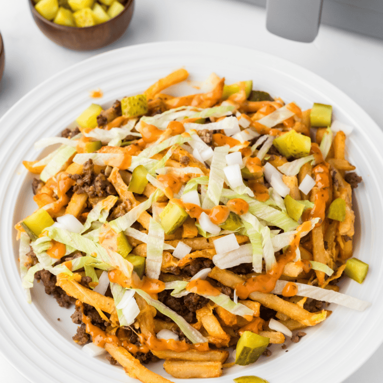 Taco Bell Baja Sauce drizzled over crispy fries, adding a creamy, zesty flavor.