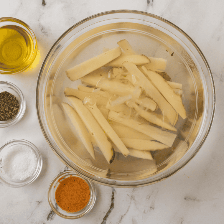 Ingredients needed for Texas Roadhouse Steak Fries Recipe on kitchen table.