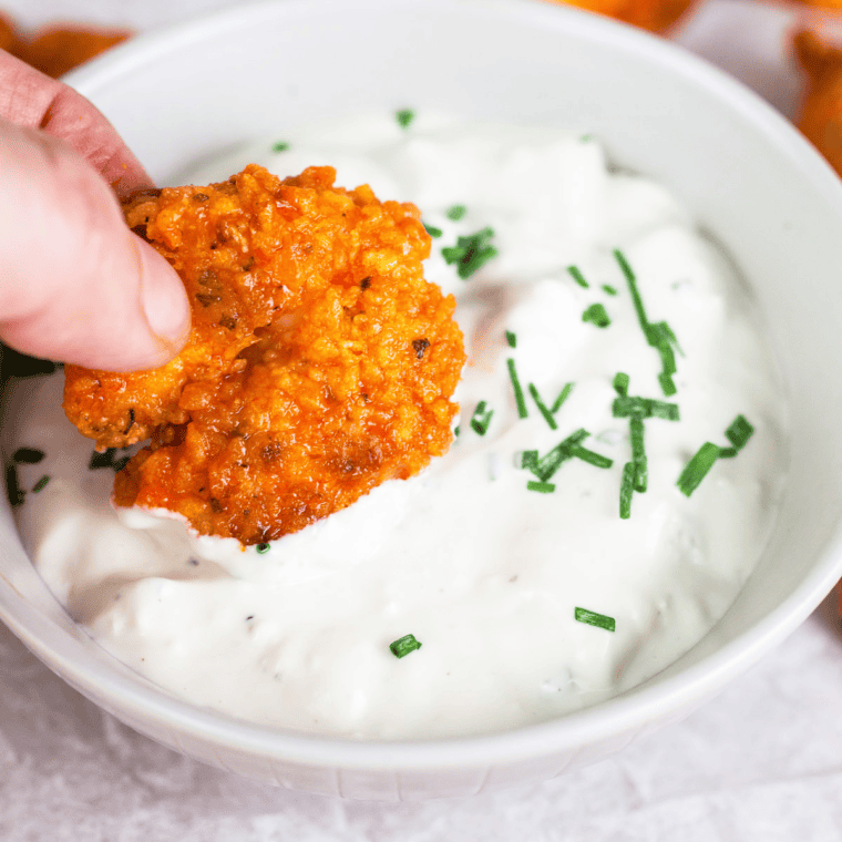 Bowl of homemade Wingstop-style blue cheese dressing with celery and wings.