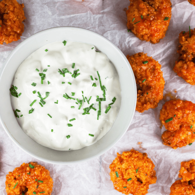 Homemade Wingstop-style blue cheese dressing in a bowl with wings and celery.