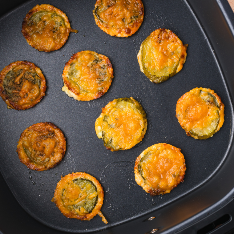 Crispy golden cheddar ranch pickle chips served on a plate, ready to eat.