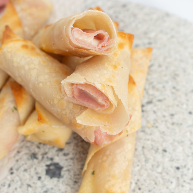 Crispy golden Air Fryer Ham and Mozzarella Cheese Sticks with melted cheese inside, served with dipping sauce.