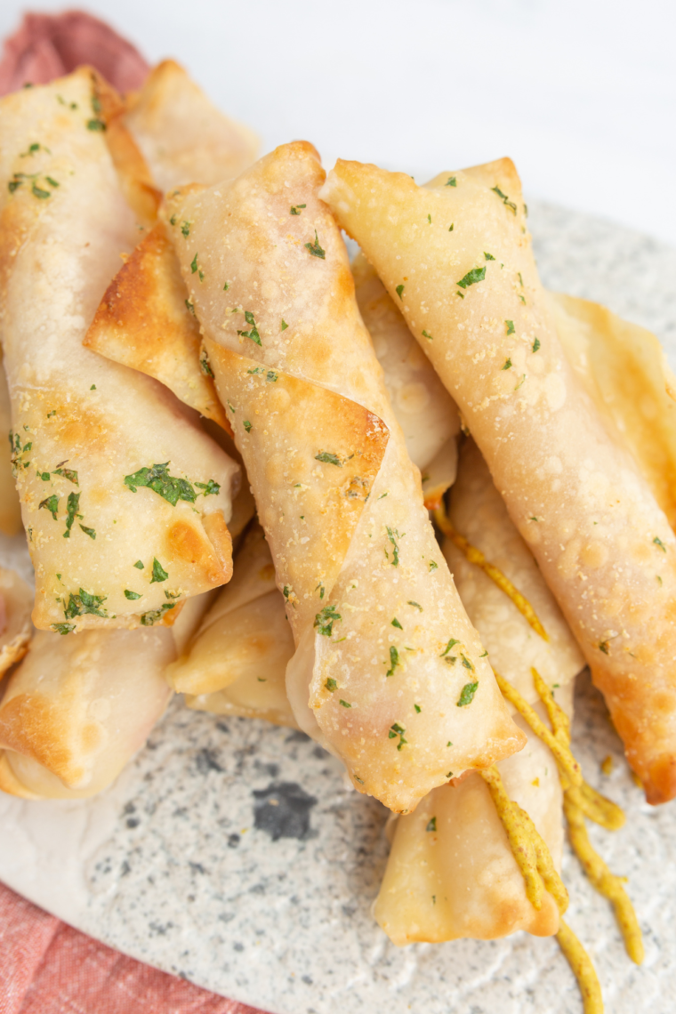 Plate of Air Fryer Ham and Mozzarella Cheese Sticks on kitchen table.