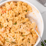 A bowl of creamy Air Fryer Lobster Bisque Pasta topped with tender lobster pieces and garnished with fresh herbs.
