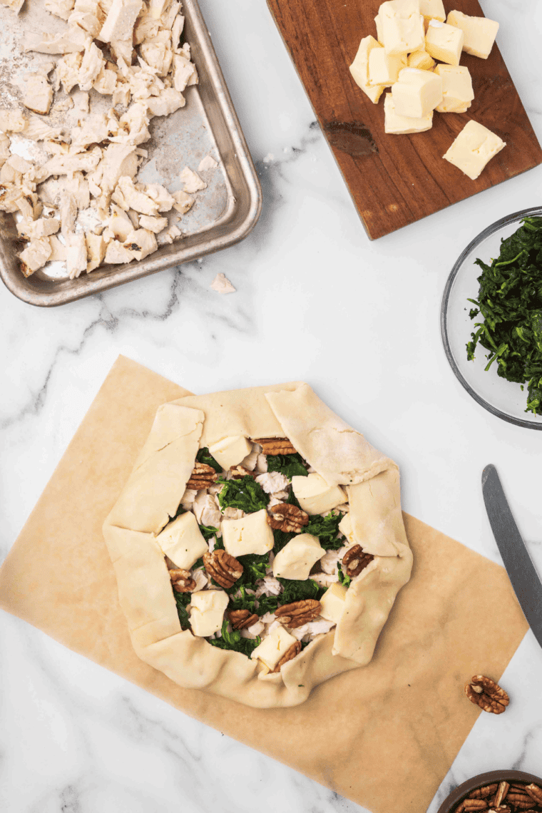 Assembled Chicken Tart on cutting board and parchment paper.