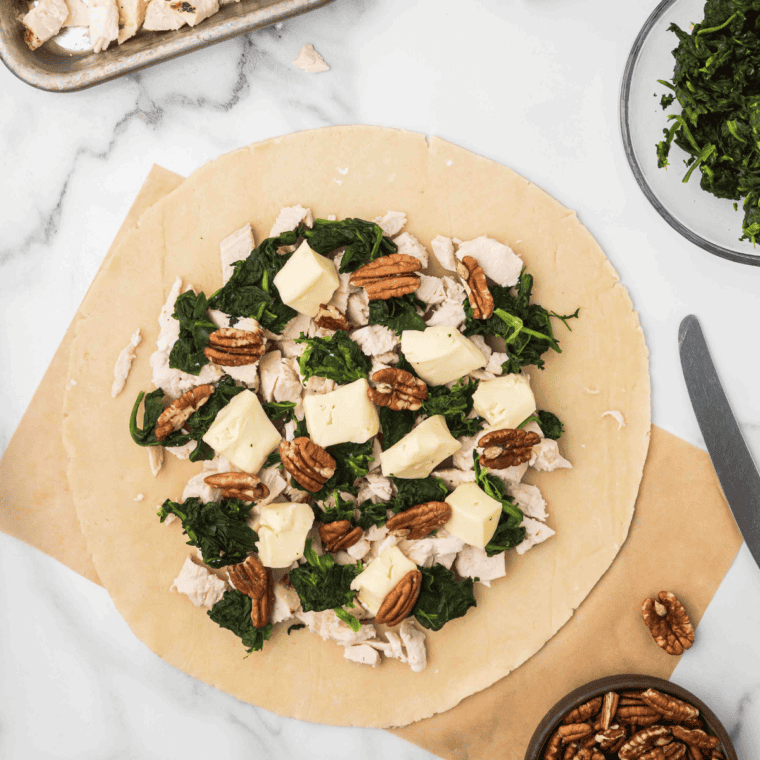 Sprinkle the pecans and brie cheese on top of the other toppings.