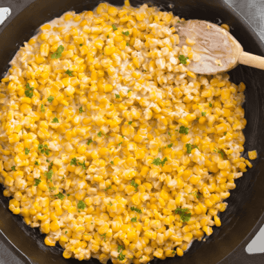 Golden, charred corn cooked in a cast iron skillet with butter and seasonings.