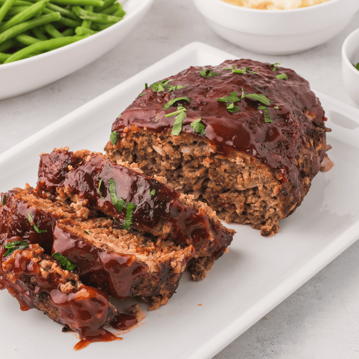 Delicious homemade Copycat Cracker Barrel Meatloaf served with mashed potatoes and sides