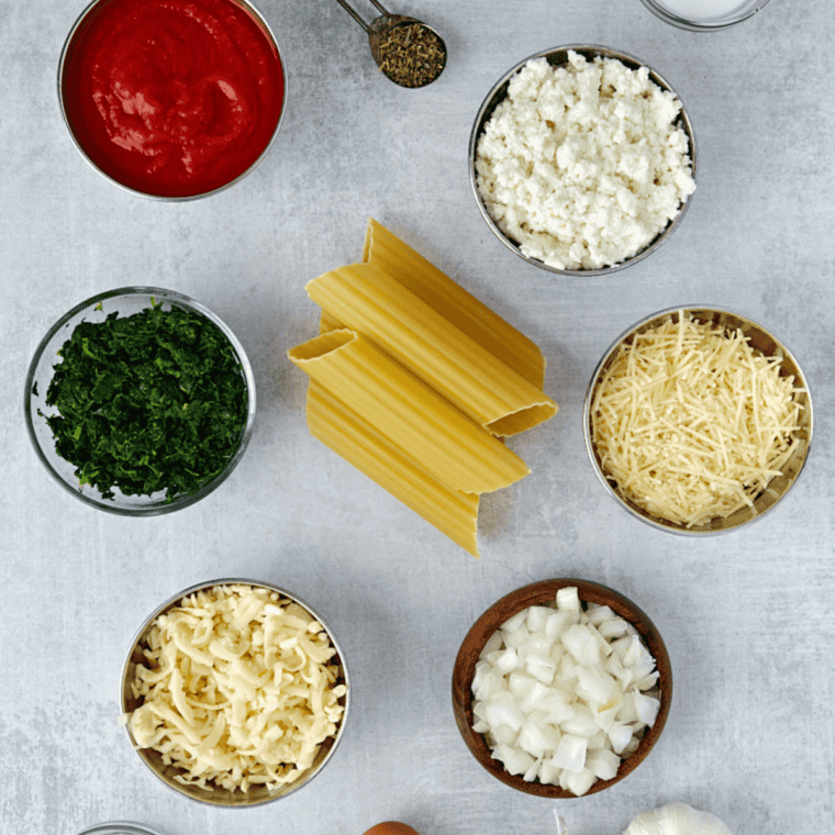 Ingredients needed for Copycat Olive Garden Manicotti on kitchen table.