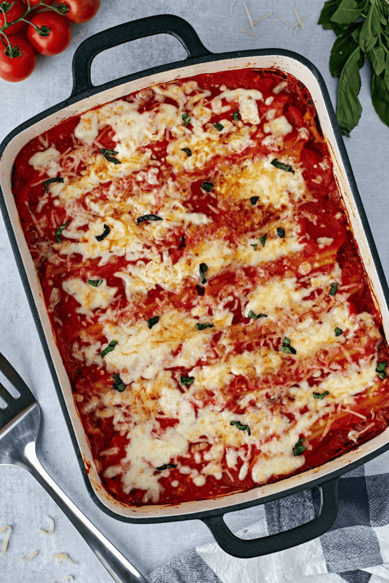 Stuffing manicotti shells with ricotta, mozzarella, and Parmesan cheese for a delicious filling.