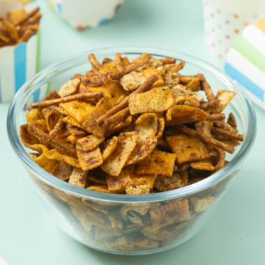 Close-up of homemade Frito Snack Mix with pretzels, nuts, and seasoned corn chips