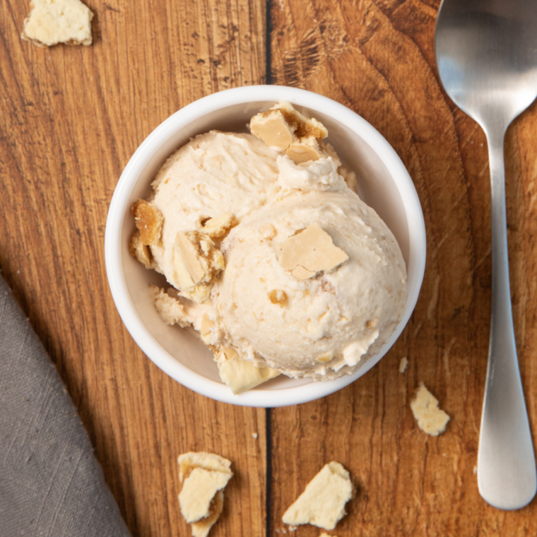 Creamy brown sugar cinnamon Pop-Tarts ice cream served in a bowl with crumbled Pop-Tart pieces on top.