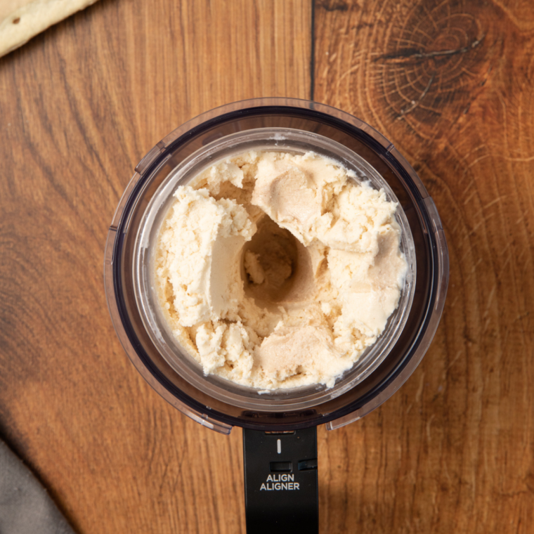 Adding chopped frozen Pop-Tarts into the center of the processed ice cream.
