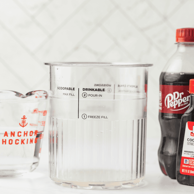 Ingredients needed for Ninja Creami Dirty Dr Pepper Slush on kitchen table.