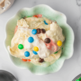 Bowl of creamy Ninja Creami M&M Blast with colorful candies mixed into rich vanilla ice cream