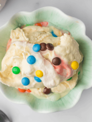 Bowl of creamy Ninja Creami M&M Blast with colorful candies mixed into rich vanilla ice cream