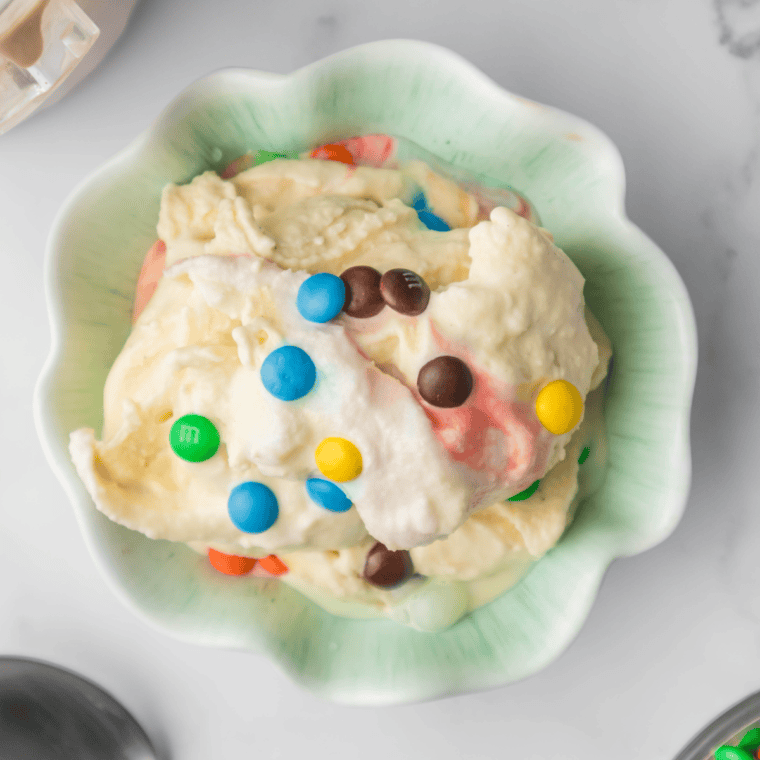 Bowl of creamy Ninja Creami M&M Blast with colorful candies mixed into rich vanilla ice cream