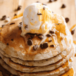 "Fluffy golden pancakes cooked on a Ninja Woodfire grill with a smoky outdoor flavor"
