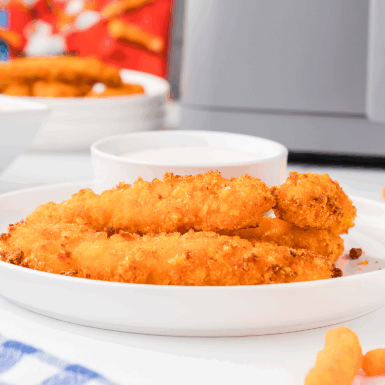 Golden and crispy Air Fryer Cheetos Chicken Fries with a cheesy coating, served with dipping sauce.