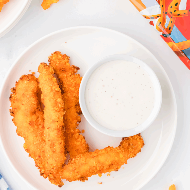 Golden and crispy Air Fryer Cheetos Chicken Fries served with a dipping sauce.
