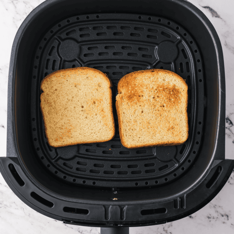 Spreading a generous layer of cottage cheese on the toasted bread