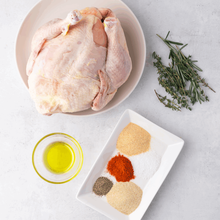 Ingredients needed for Air Fryer Frozen Whole Chicken on kitchen table.