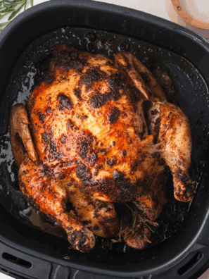 Golden-brown whole chicken cooked in the air fryer, crispy on the outside and tender inside.
