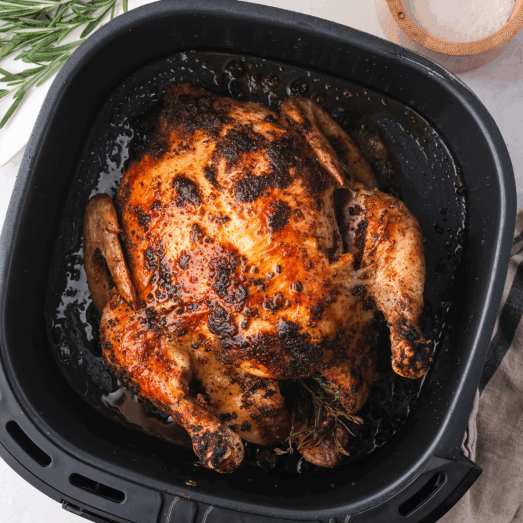 Golden-brown whole chicken cooked in the air fryer, crispy on the outside and tender inside.